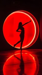 Silhouette of a Woman Dancing in Front of a Red Circular Light