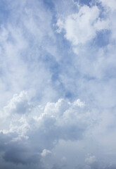 Canvas Print - it's a blue sky with atmospheric puffy clouds.