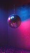 © rehan - A Disco Ball Hanging in a Room with Blue and Pink Lighting