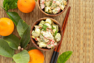 Crab Celery Egg Salad and mandarin leaves on bamboo placemat.