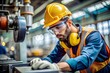 © Yauhen - A focused worker wearing safety gear in an industrial setting.