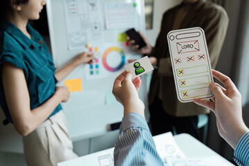 Wall Mural - creative team brainstorming and developing ux ui design concepts for mobile application