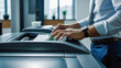 © Aliaksandra - A businessman makes copies using a modern printer in a bright office