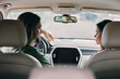 © SHOTPRIME STUDIO - Young couple talking while driving in a car, showcasing a relaxed atmosphere and connection between them