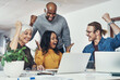 © peopleimages.com - Winning, celebration and team of business people on laptop for goal, bonus or good news at startup. Excited group, creative and cheers for victory, success or award achievement with company milestone