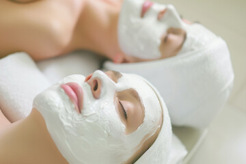 Wall Mural - Two women with white face masks on their faces