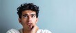 © HN Works - Confused young Hispanic man unable to decide contemplating choices with a puzzled expression in a copy space image