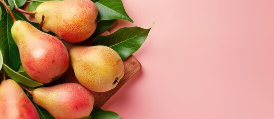 Canvas Print - A wooden board featuring fresh pears and leaves set against a pink backdrop with copy space image