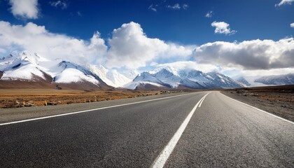 empty asphalt road with snow mountains in blue cloud sky