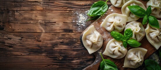 Aufkleber - Wooden background showcasing a board with uncooked dumplings and fresh basil featuring copy space image included