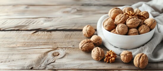 Aufkleber - White wooden background with a bowl of appealing walnuts featuring copy space image