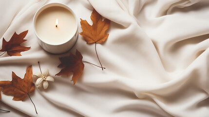 Wall Mural - Flat lay with fabric draping, fallen leaves and a beautiful candle on a white tabletop