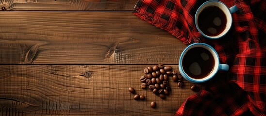 Poster - Coffee cups beans and red plaid fabric on a wooden surface with copy space image