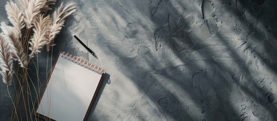 Aufkleber - Pampas grass beside notebook on a grey background with copy space image
