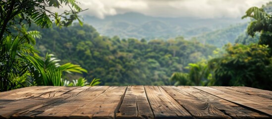 Poster - Wooden table with a blurred backdrop of mountains and lush greenery providing a copy space image for displaying products against a stunning forest landscape