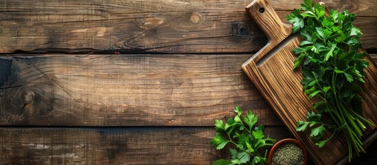Poster - Top view of a wooden table with a cutting board cumin and parsley providing copy space for text