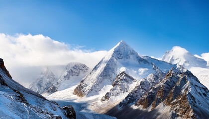 Wall Mural - rocky mountain peaks with snow on blue sky background creative picturesque inspiring landscape of mountain peaks with snow rocky mountain peaks with snow caps on sunny day