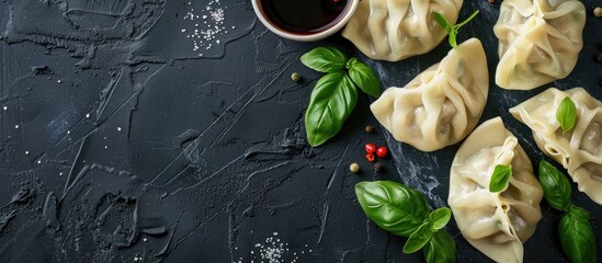 Aufkleber - Dumplings and basil displayed on a black surface with copy space image