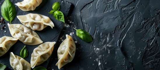 Aufkleber - Dumplings and basil displayed on a black surface with copy space image