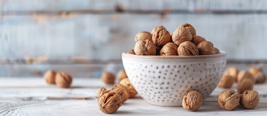 Aufkleber - White wooden background with a bowl of appealing walnuts featuring copy space image