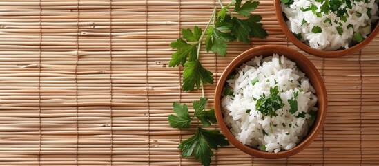 Poster - Top view of appetizing boiled rice bowls garnished with parsley on a bamboo mat suitable for adding text in the copy space image