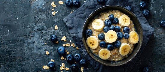 Aufkleber - Top down view of a healthy oatmeal bowl adorned with blueberries and banana slices accompanied by additional fruits Ample space for text on the image