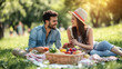 © Tuwaporn - Young couple enjoying a romantic picnic in the park