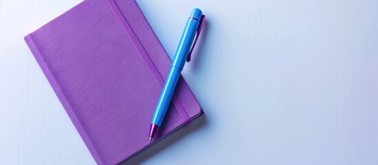Poster - Purple notebook and blue pen viewed from above on a white background making it suitable for school or office themed wallpapers with a flat lay composition and ample copy space image