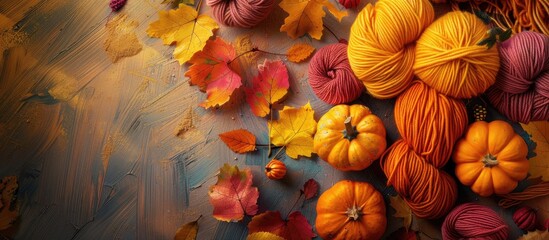 Poster - Autumn themed composition with wool yarn skeins yellow leaves pumpkins and a hand knitting concept for Halloween and autumn creativity includes copy space image