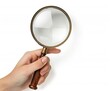 © CozyNessAI - Closeup view of hand holding magnifying glass isolated on white background.