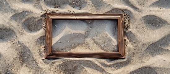 Fototapete - Rectangular wooden frame displayed on soft sand with copy space image
