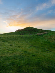 Wall Mural - Beautiful sunrise view on a green hill.