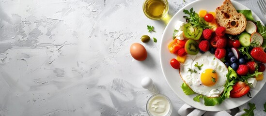 Poster - A delicious flat lay breakfast arrangement with fruits salad egg bread vegetables cheese and berries all beautifully displayed with ample copy space image