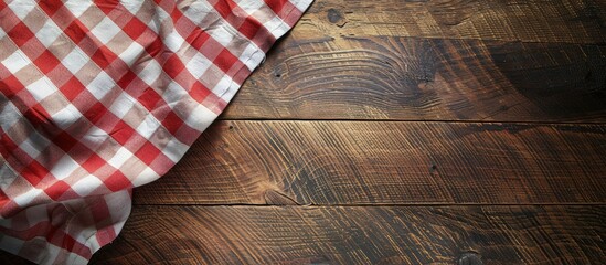 Poster - A bird s eye view of a wooden dining table adorned with a red and white checkered tablecloth with room for a copy space image