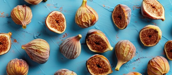 Canvas Print - Dried figs arranged on a blue backdrop with copy space image