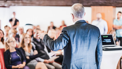 Wall Mural - speaker at business conference with public presentations. audience at the conference hall. entrepren