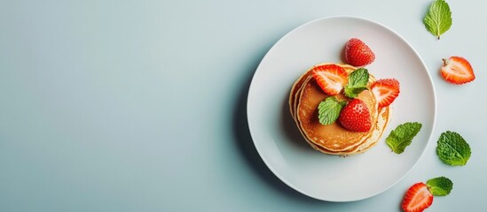 Fototapete - Small grain pancakes with strawberries quick healthy breakfast pancake porridge set against a gray background. with copy space image. Place for adding text or design