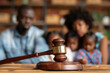 © Valeriia - Child-custody. Family law, family right judgement court justice legislation concept. Wooden judge's gavel and African American family with child kid on background awaiting judge decision