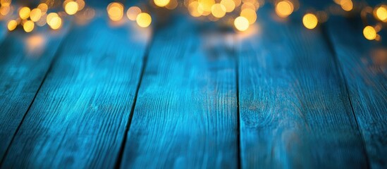 Poster - Decorative bokeh lights on a blue wooden surface Christmas backdrop. with copy space image. Place for adding text or design