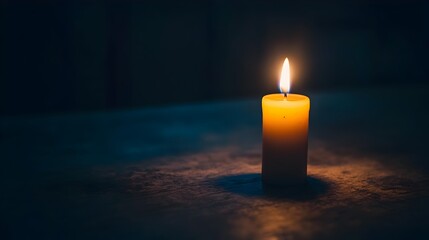 A lone single candle flame burning in the stillness of the dark its warm glow and soft light casting a peaceful contemplative atmosphere and symbolizing the power of hope faith and