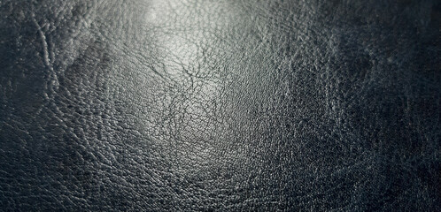 abstract dark leather texture, textured background close-up surface with light and space for design