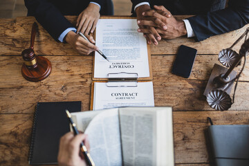 Wall Mural - Lawyer is giving legal advice to a businessman in the legal counsel's office. Meeting with the legal team to discuss the contract agreement and its signing.