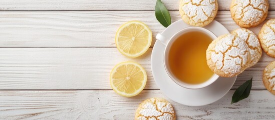Poster - Lemon Crinkle Cookies a home baked sweet and tangy treat with a teacup on a white wooden background with copy space
