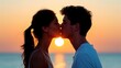 © Inlovehem - Romantic couple having a sweet kiss at sunset by the beach, with the sun setting behind them casting a beautiful glow.