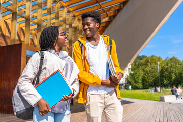 Happy african students walking together in the university campus