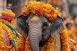 © Ninoshik - An elephant wearing a colorful traditional outfit adorned with flowers and decorations