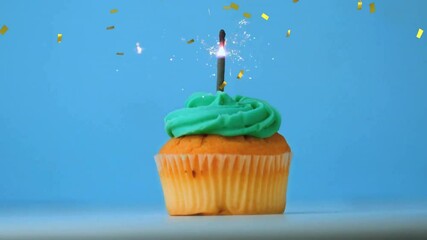 Wall Mural - Cupcake with lit candle and falling confetti animation on blue background