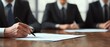 © Steveandfriend - Close-up of a business person signing a document at a desk, highlighting professionalism and focus in a corporate setting.