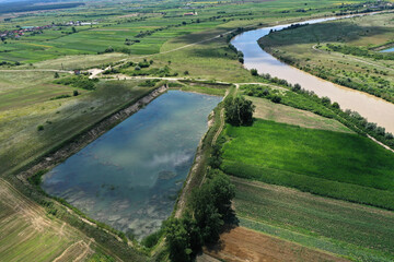 Aerial view of river gravel and sand ballast open pit mining abandoned lake