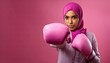 © Walk - Arab woman wearing Hijab with Pink boxing glove, fighting breast cancer awareness month